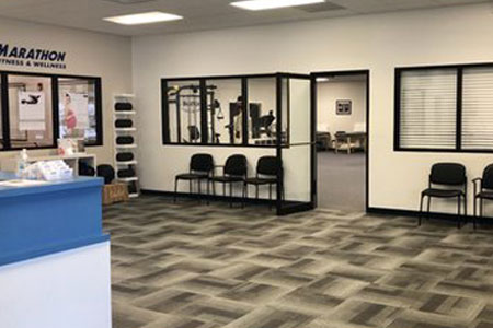 The front desk and the physical therapy treatment room at Marathon's clinic in Pembroke, MA.